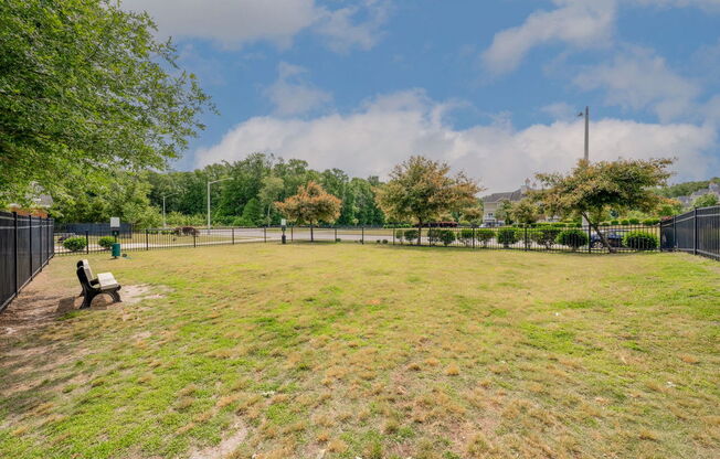 large fenced bark park with bench at pet-friendly Fenyck Manor Apartments for rent in Chesapeake, VA