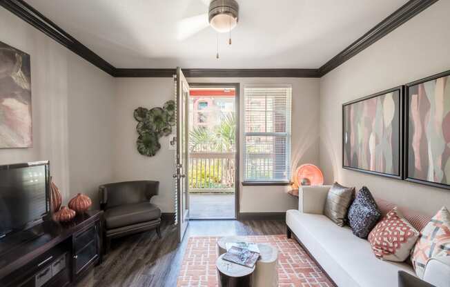 a living room with a couch and a door to a balcony