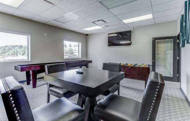 Gaming room with a table and chairs and a television  at Union Heights Apartments, Colorado Springs, CO