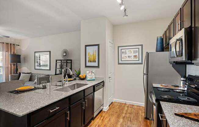 A kitchen with a refrigerator, microwave, and oven. at Bridge at Southpark Meadows, Austin, Texas