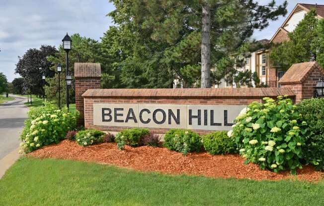 a sign that reads beacon hill in front of a building at Beacon Hill and Great Oaks Apartments, Rockford