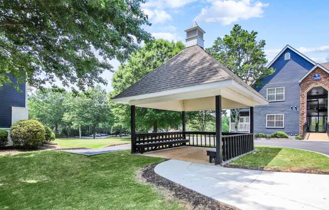 a gazebo with a blue building in the background