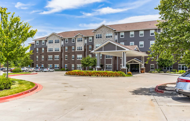 a large building with a driveway and a parking lot