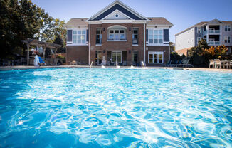 a large swimming pool in front of a house