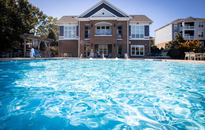 a large swimming pool in front of a house