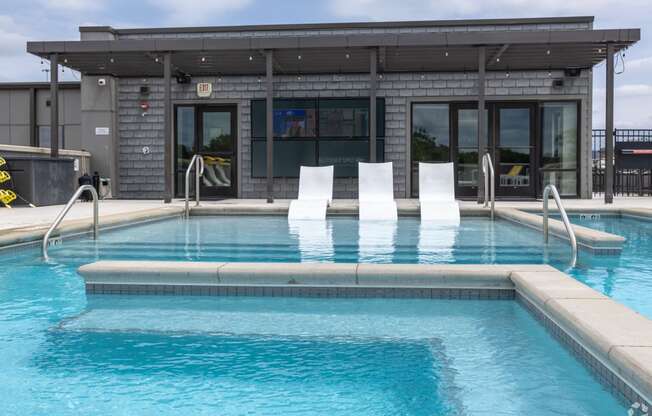 a swimming pool with a building in the background