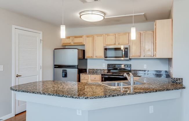 a kitchen with a granite counter top and a