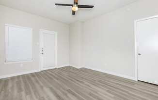 Apartments in Tempe, AZ for Rent – Sono Tempe –  an empty living room with white walls, hardwood floors and a ceiling fan