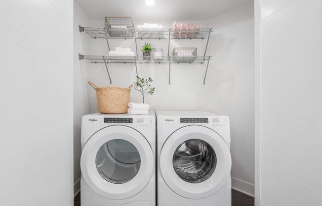 a washer and dryer in a laundry room with white walls