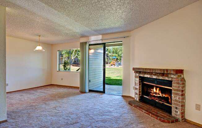 Chambers Creek Vacant Apartment Living Room With Fireplace & Patio Sliding Door