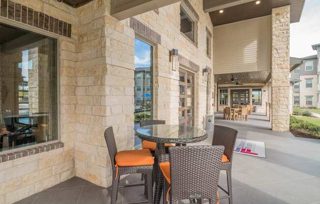 A patio with a table and chairs is shown.