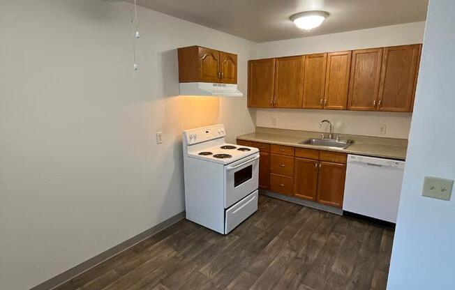 a kitchen with a white stove and a ceiling fan