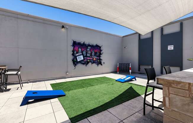 A room with a blue mat on the floor and a chair.