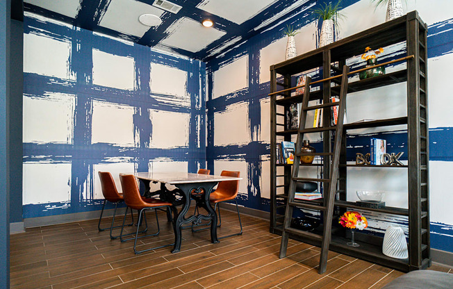 a dining room with blue walls and a table and chairs