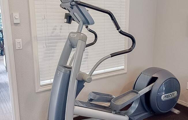 A Prado elliptical trainer is on the floor in a room.