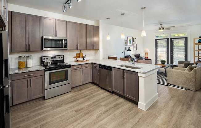A modern kitchen with wooden cabinets and a granite countertops
