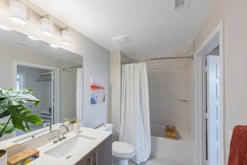 a bathroom with a shower and a sink and a mirror