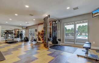 A spacious home gym with a variety of exercise equipment.