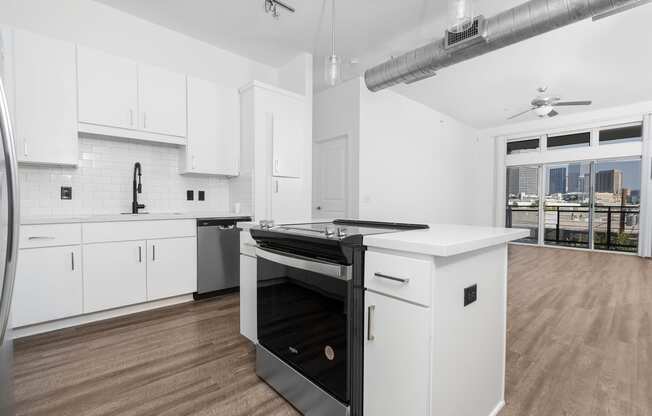 a kitchen with white cabinetry and a black stove top oven