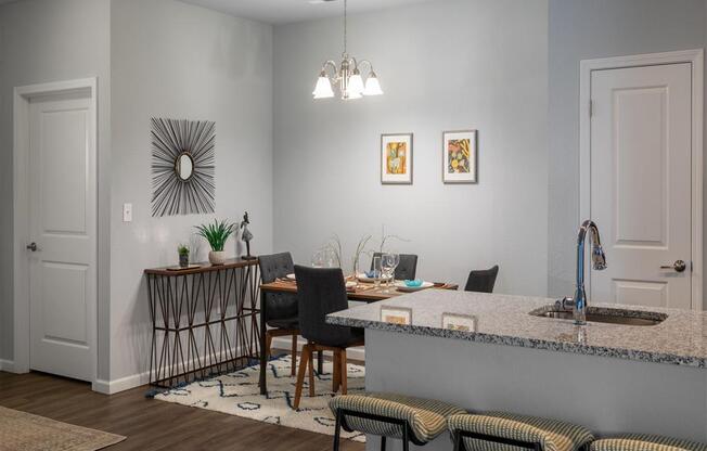 a kitchen and dining room with a table and chairs