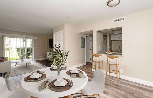 A dining room with a white table set for six.