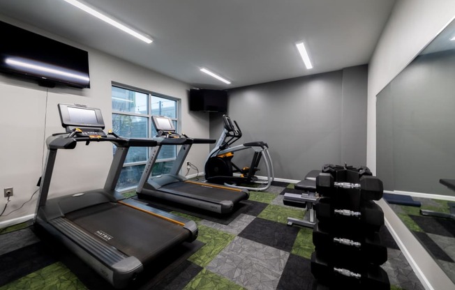 a gym with treadmills and other exercise equipment in a building at 310 at Nulu Apartments-Student, Louisville, KY 40202