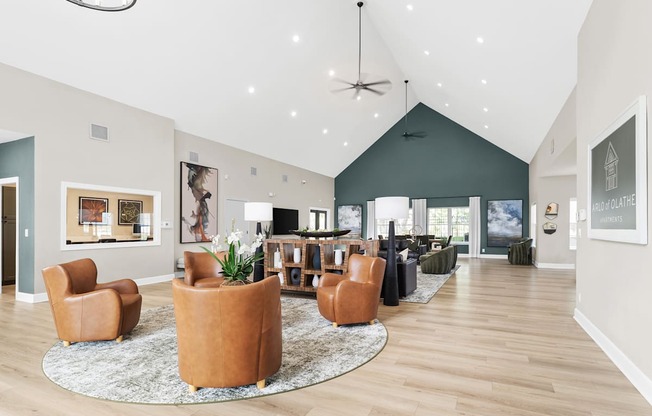 A living room with a rug and chairs.