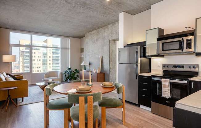 A modern kitchen with a dining table set for two.