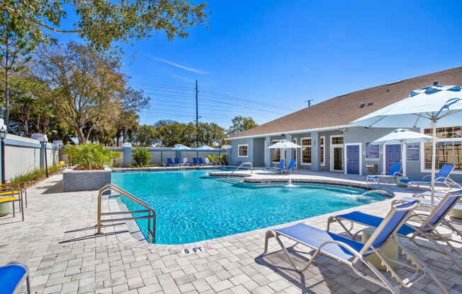 resort style swimming pool is in front of clubhouse with lounge chairs at Reserve at Temple Terrace, Temple Terrace