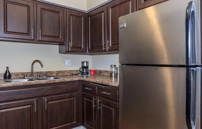 a kitchen with stainless steel appliances and wooden cabinets