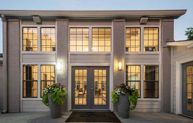 A house with a front porch and two potted plants.