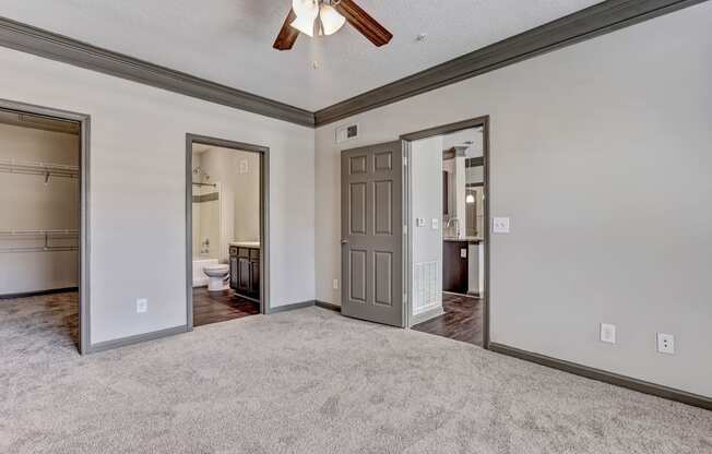 Carpeted Bedroom With Attached Bathroom & Tall Ceilings