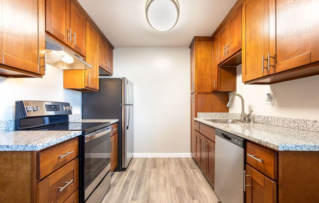 a kitchen with wooden cabinets and stainless steel appliances at Element LLC, Sunnyvale