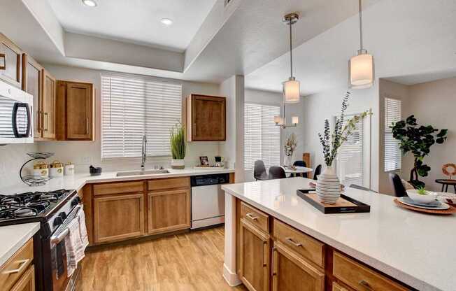 A kitchen with wooden cabinets and a white countertop.