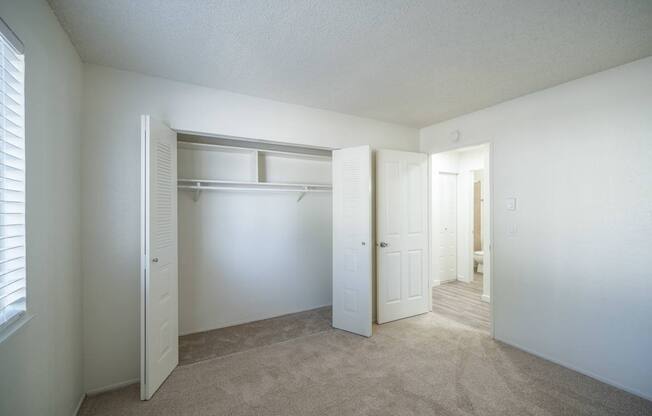 Large bedroom with carpeted floors and spacious closet at Kirkwood Meadows Apartments in Pocatello, ID