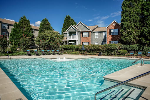 A swimming pool in front of a residential building.