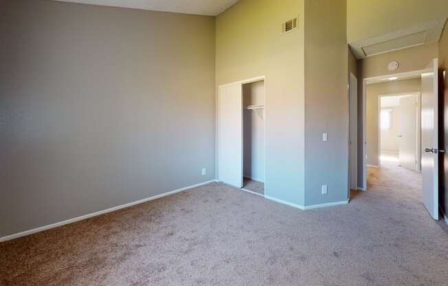Ontario CA Apartments for Rent - Rancho Vista - Unfurnished Bedroom With Lush Carpet Flooring, a Closet, and Natural Lighting From the Window
