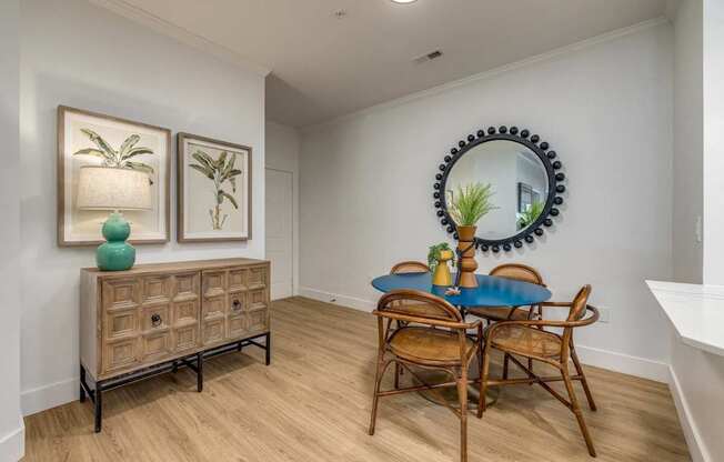 A dining room with a blue table and chairs.