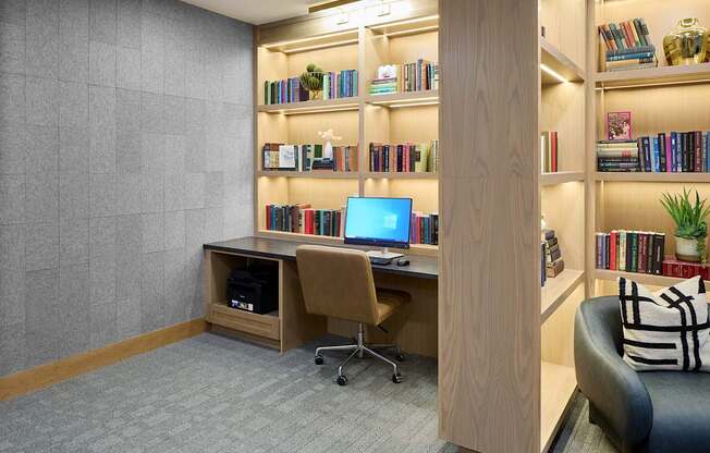 A room with a desk, chair, and bookshelf.