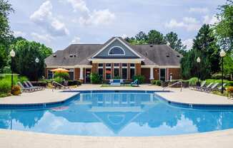 a swimming pool with a house in the background