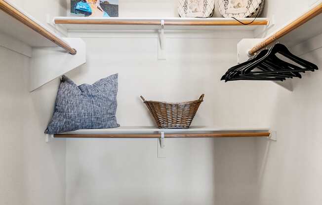 A small closet with a bench and a shelf.