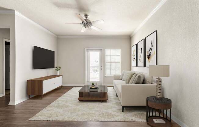 A living room with a white couch, a coffee table, and a ceiling fan.