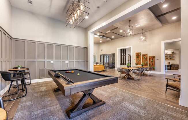 A billiard table is in the middle of a room with a pool table.