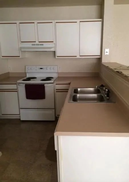 a kitchen with a sink stove and cabinets at EDGEWOOD AT GABLES Apartments, TULSA, OK