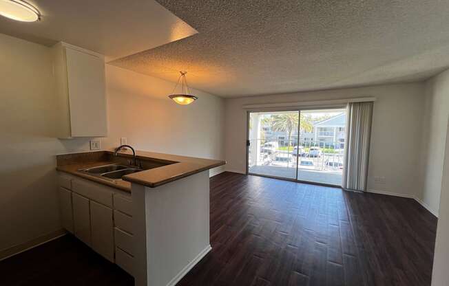 A kitchen with a sink and a window.