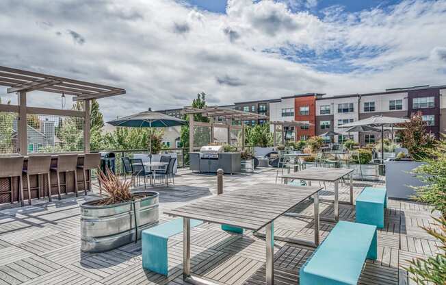 Outdoor patio with tables and benches and umbrellas at Platform 14, Hillsboro, OR