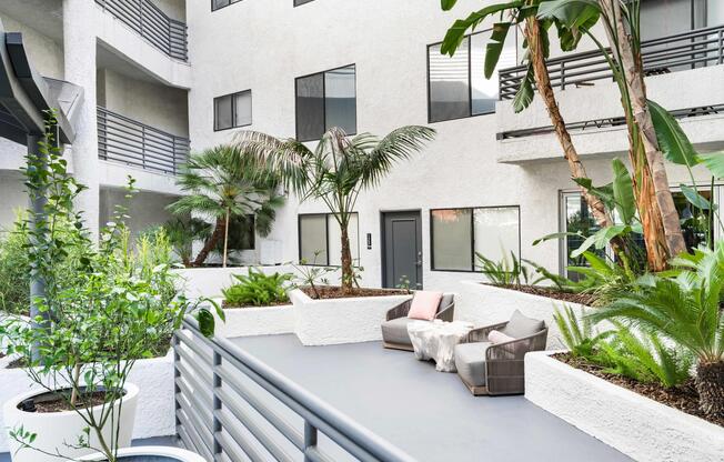 Find your calm in our lush courtyard retreat with seating nooks, tropical greenery, and a relaxed, private feel.