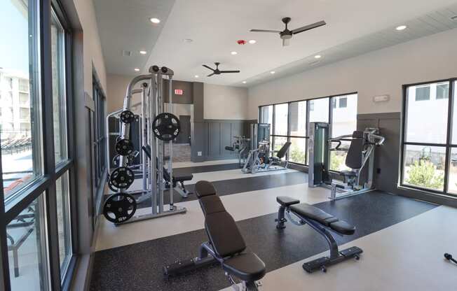a gym with exercise equipment and windows in a building at The Crest at Acworth, Acworth, GA