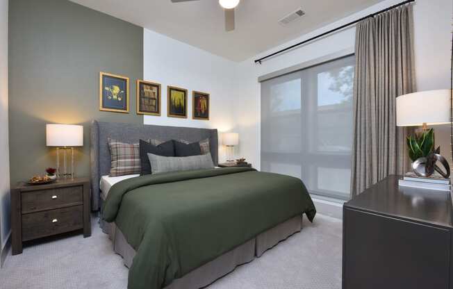 Bedroom with cozy bed and lights at The Flats at West Alabama, Houston, 77027