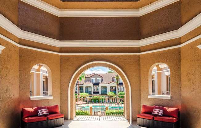 Covered seating area overlooking the pool and courtyard, perfect for relaxing outdoors.